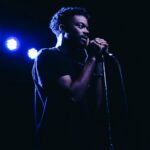 man standing while holding microphone