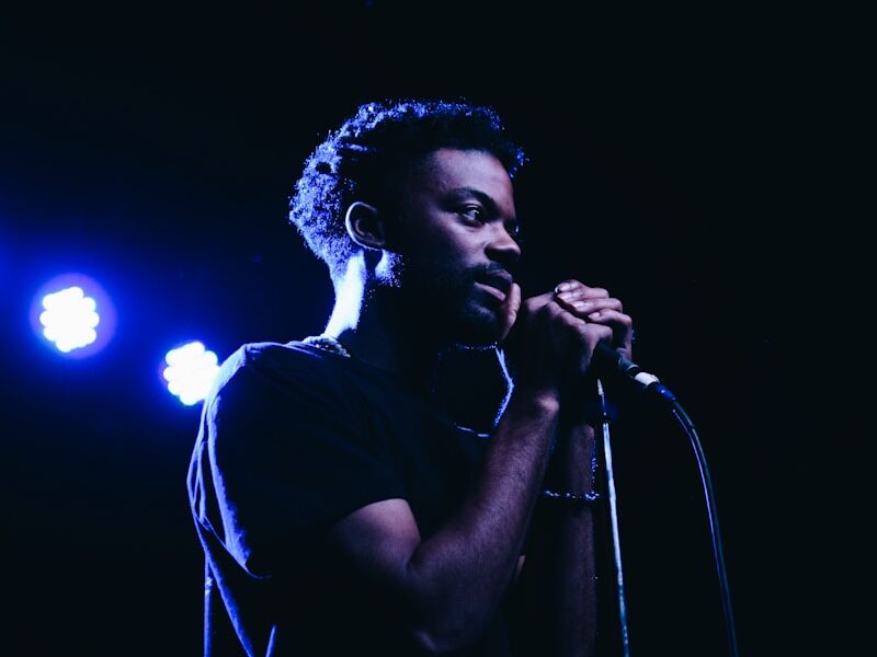 man standing while holding microphone